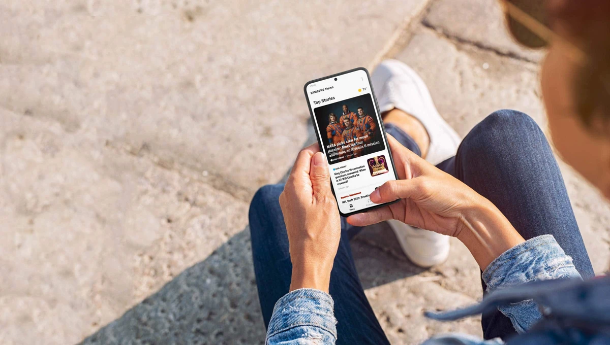 Samsung News app shown on a Galaxy phone in Samsung’s 2023 launch promotional image