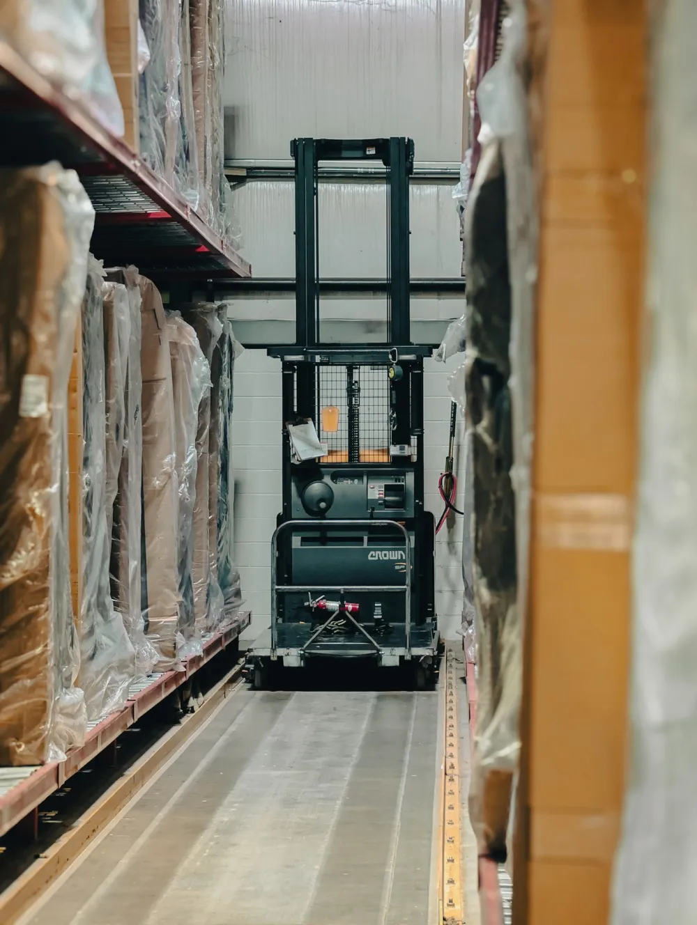 Warehouse aisle with palletised stock and handling equipment